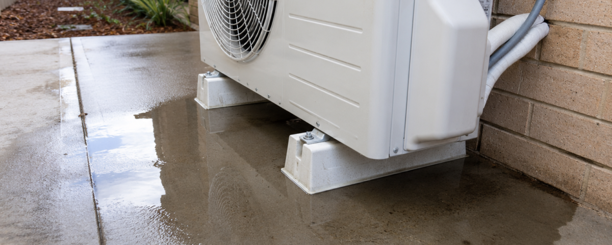 Water pooling around an outdoor reverse cycle air conditioning unit during a normal winter defrost cycle while operating in heating mode.