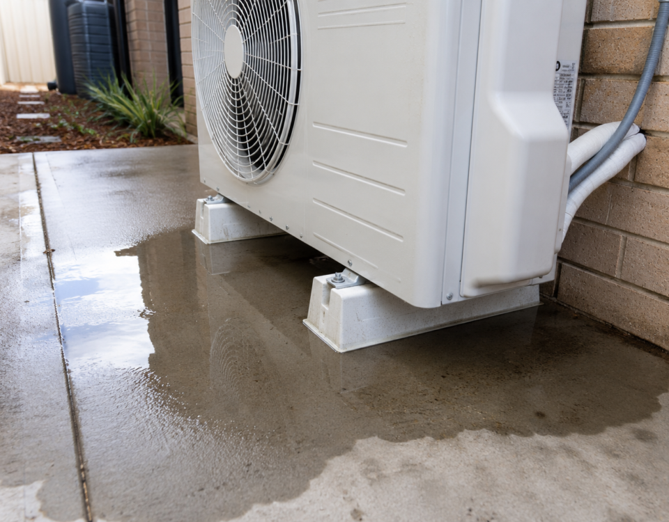 Water pooling around an outdoor reverse cycle air conditioning unit during a normal winter defrost cycle while operating in heating mode.