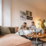 Family relaxing together in a warm, comfortable living room during winter with a reverse cycle heating system keeping the home cosy.