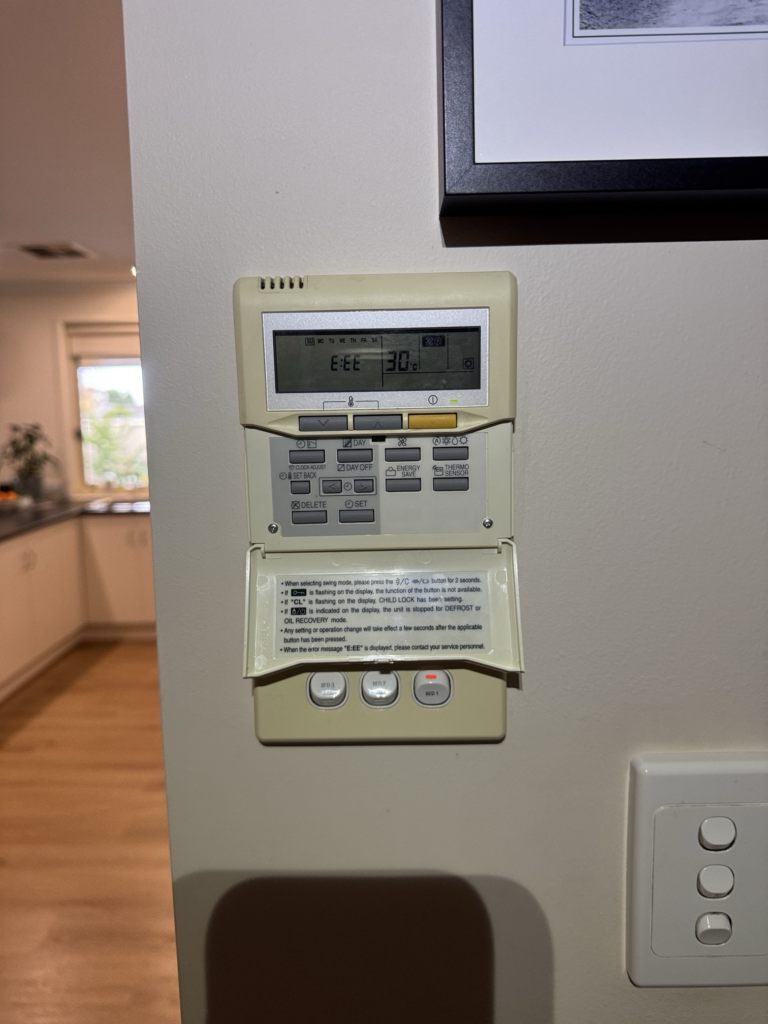 Fujitsu ducted air conditioning controller displaying an E01 error code before replacement at a home in Seacombe Gardens.
