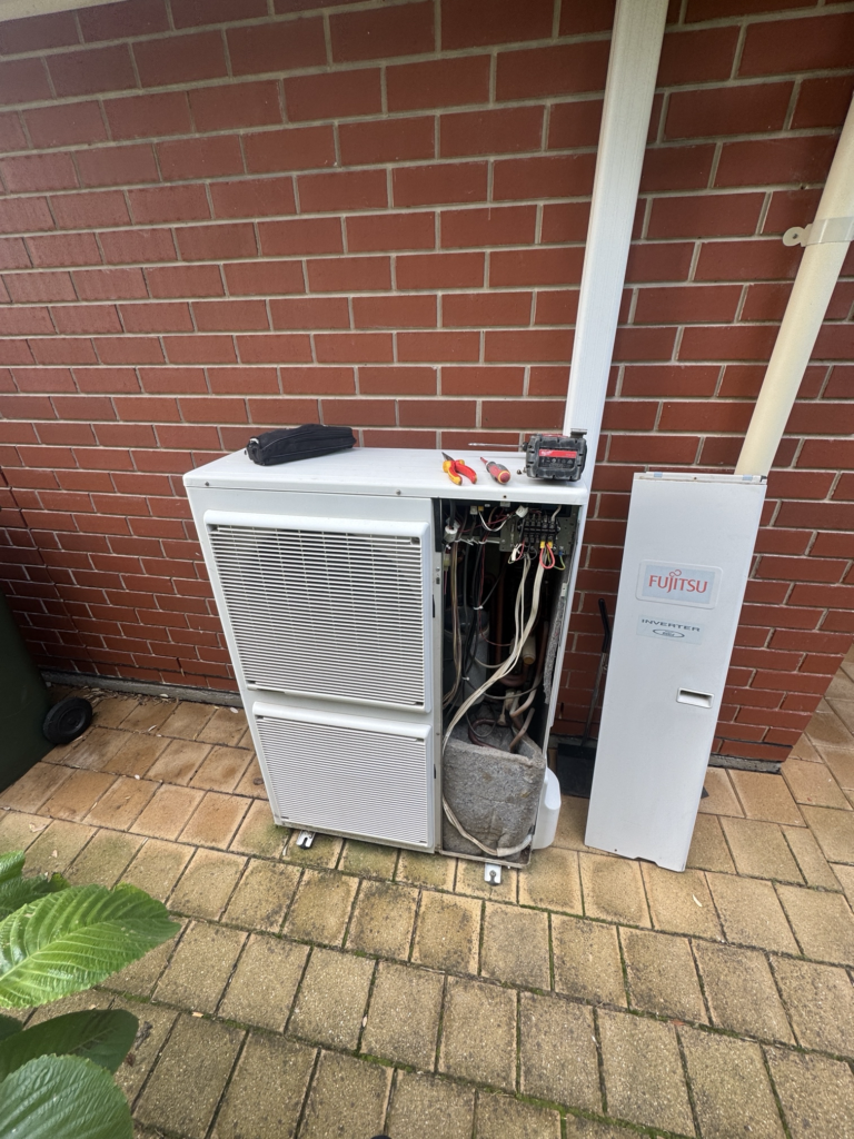 Original Fujitsu ducted air conditioning outdoor unit being inspected by Morphett Air after an E01 error code was reported at a home in Seacombe Gardens.